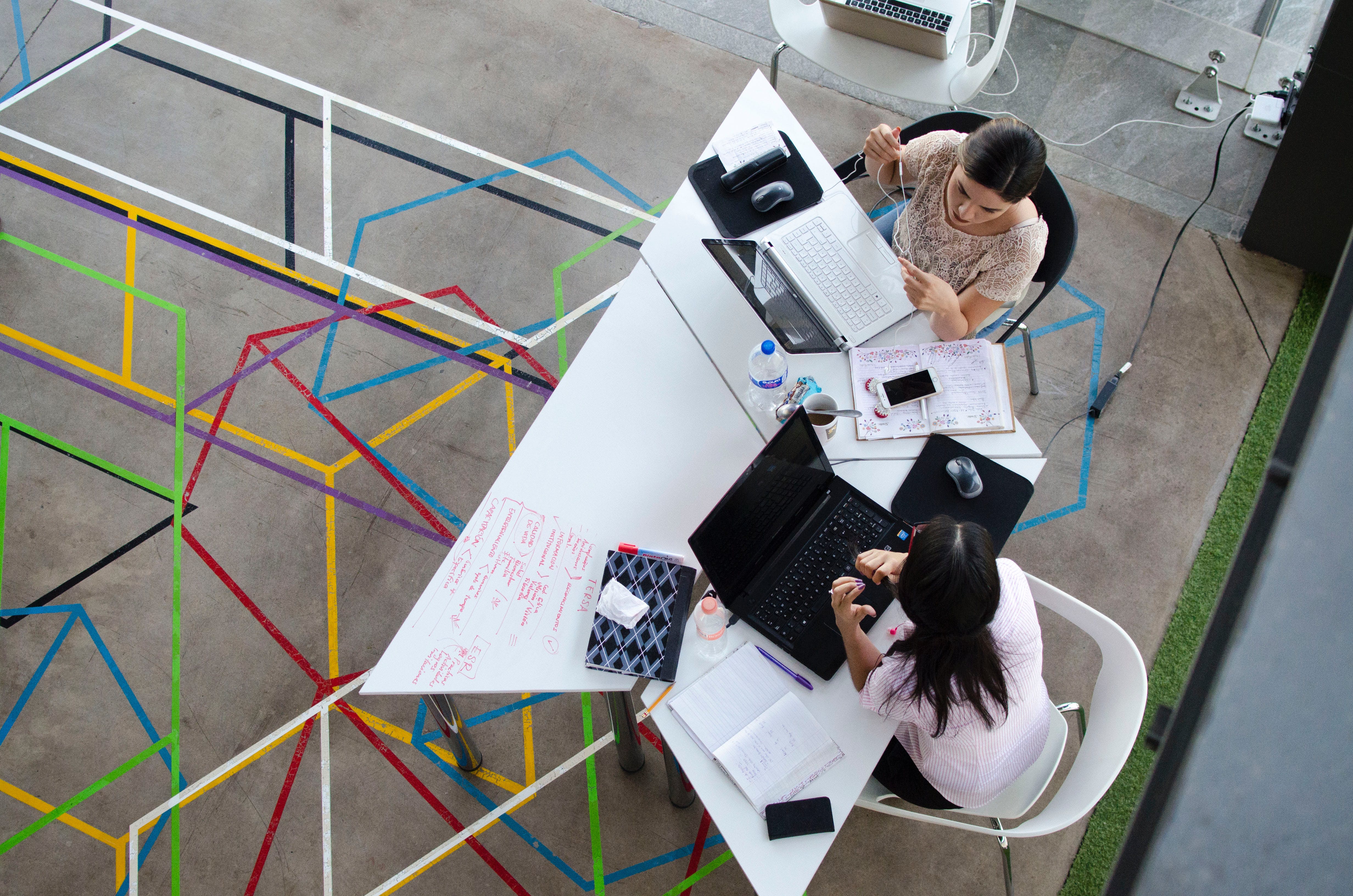 AI and Remote Work. A group of women sitting at a table with laptops.