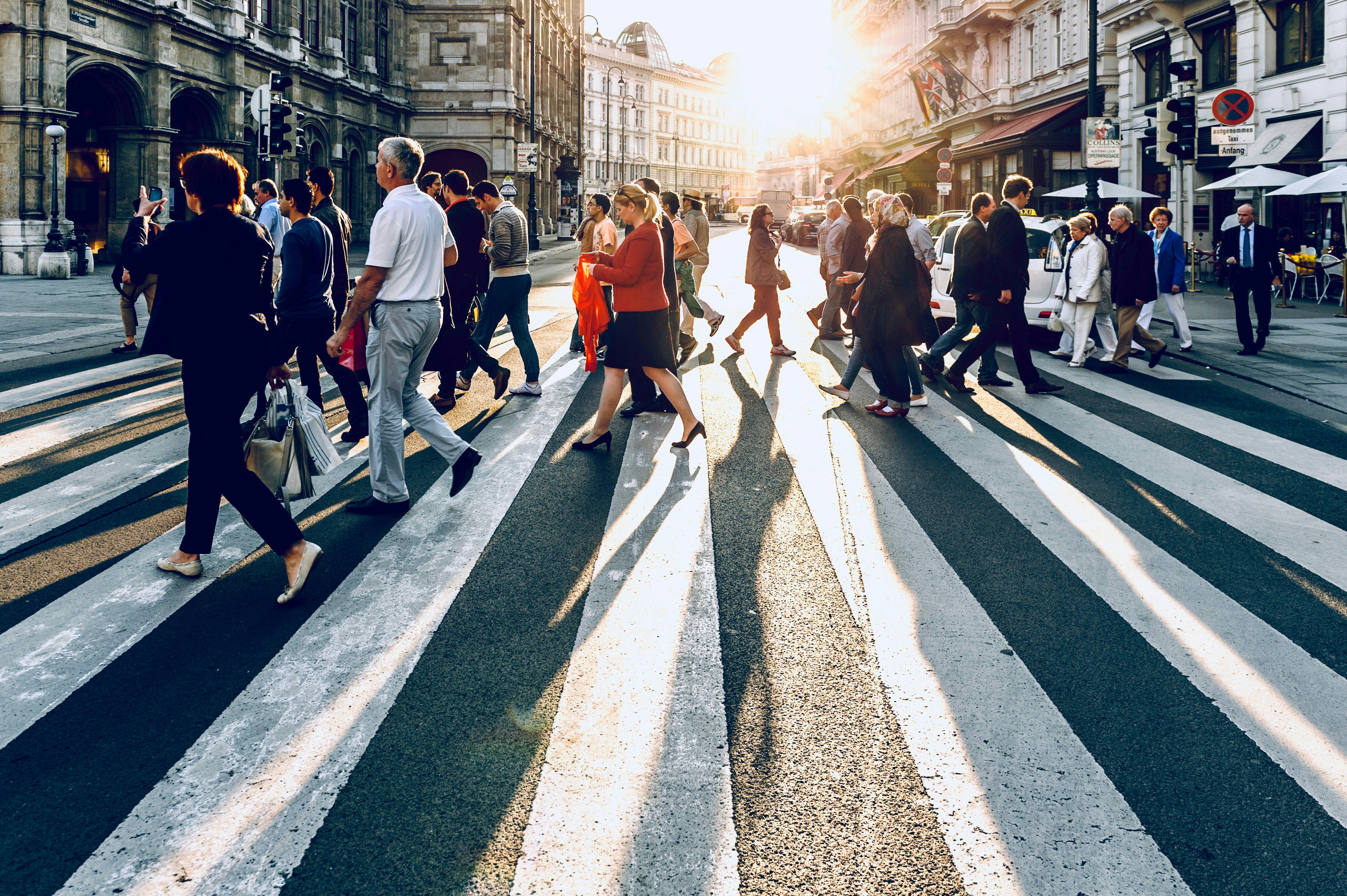 Optimize your contact center for the holiday rush. Woman crossing busy street.