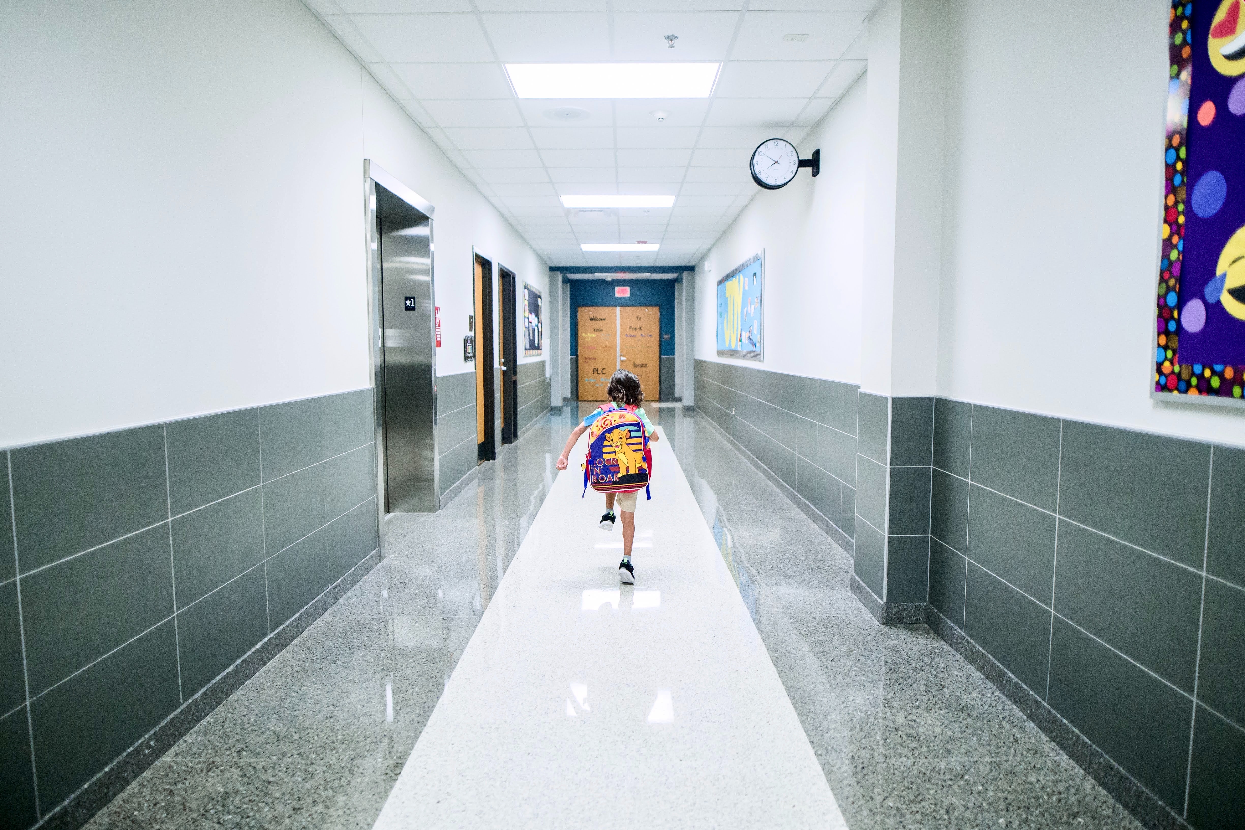 Streamlining Visitor Management. Child walking down school hallway.
