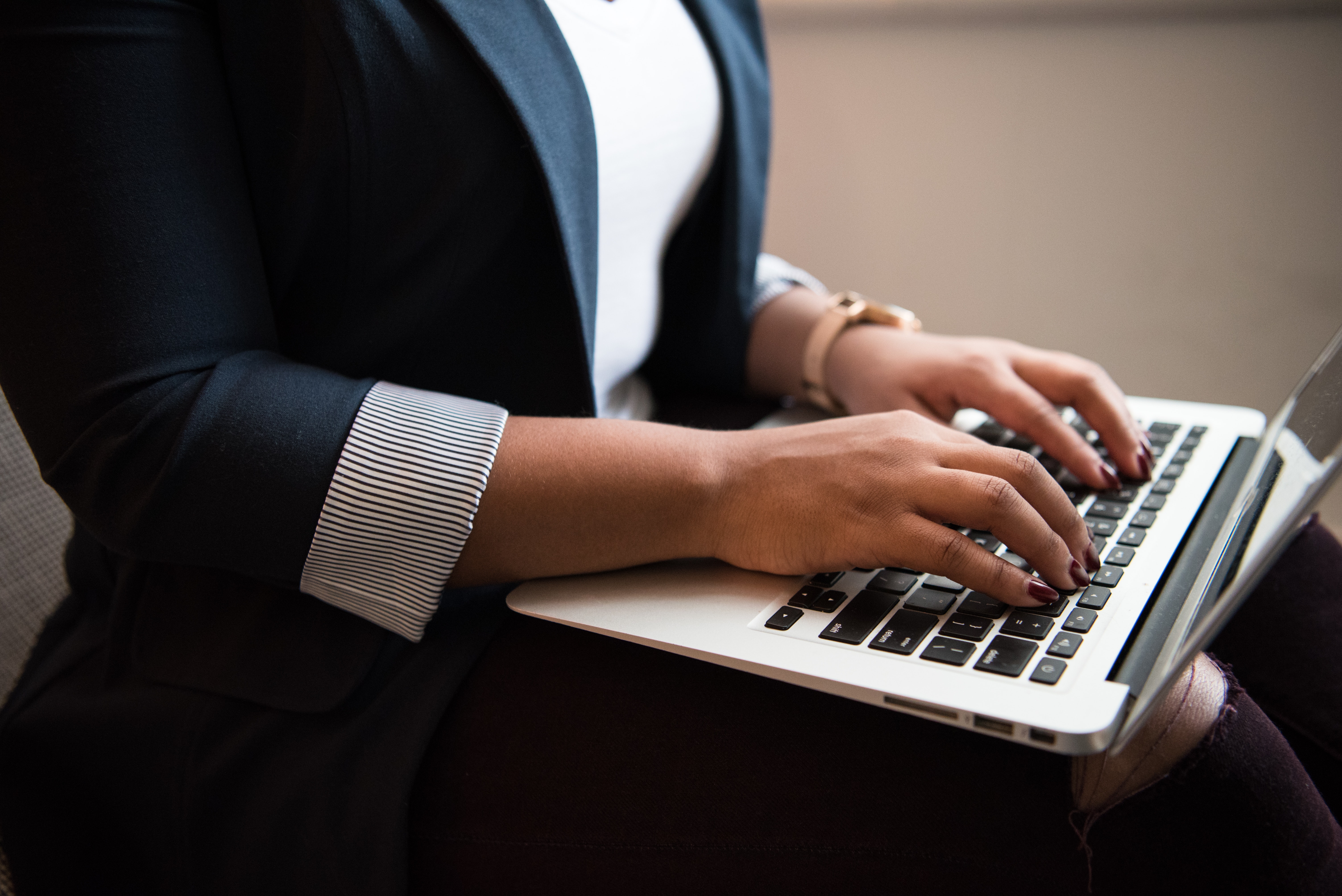 Remote Onboarding with MS Teams. An image of employee typing on a laptop.