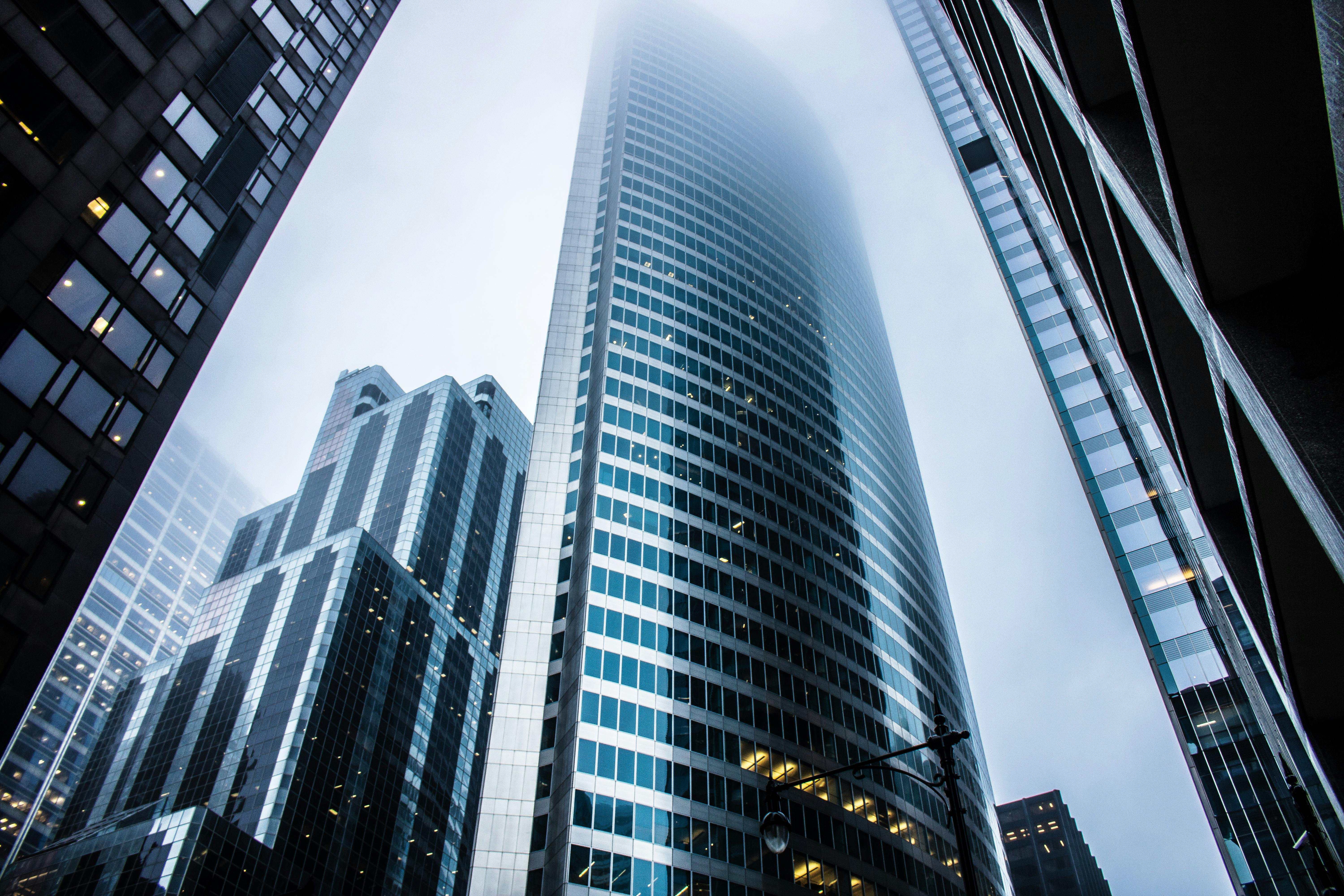 Cloud Communications in EMEA. City high-rise disappearing into the fog, evoking a sense of urban isolation and beauty.
