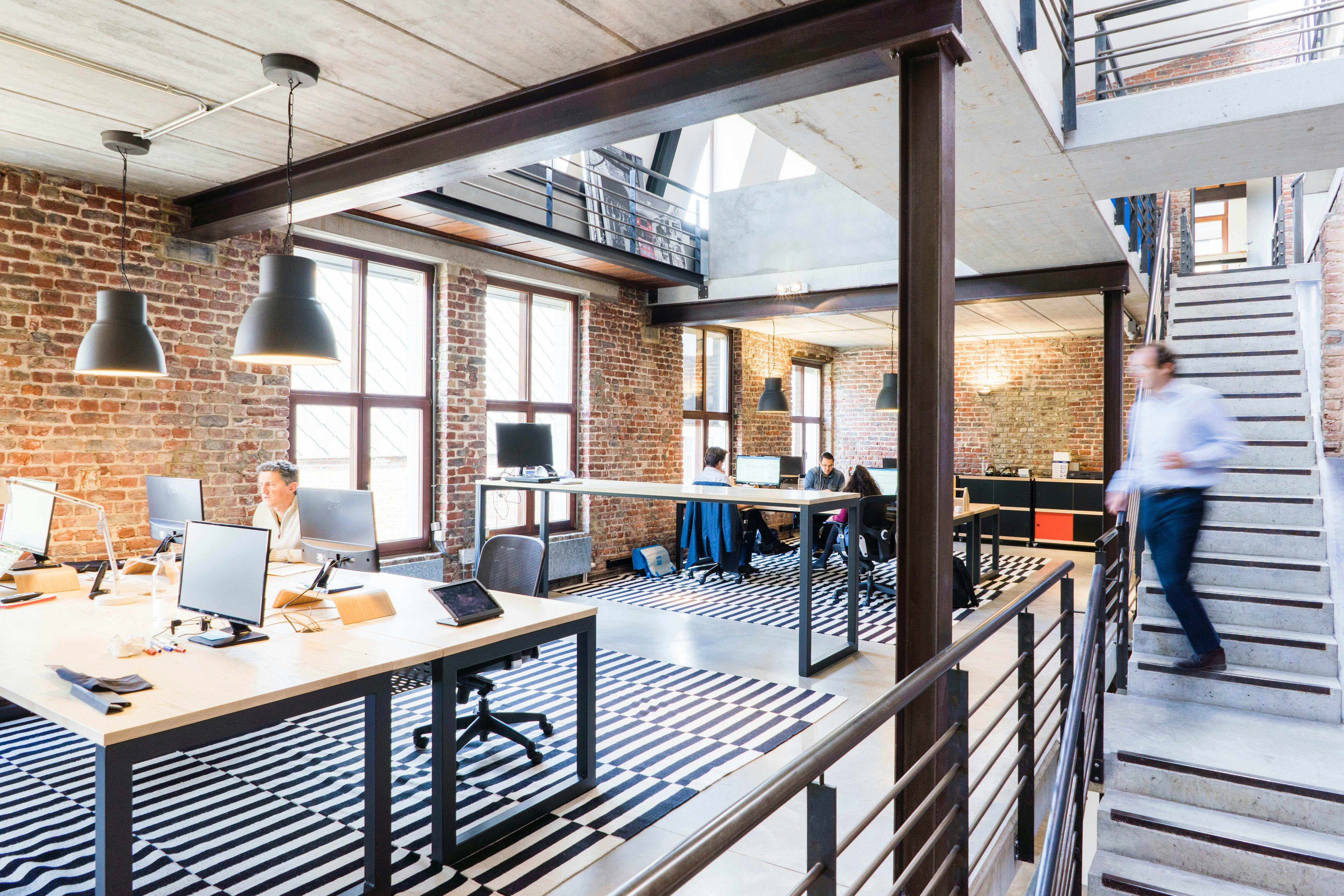 Multi-Channel Communication. Modern office space with staircase and desk.