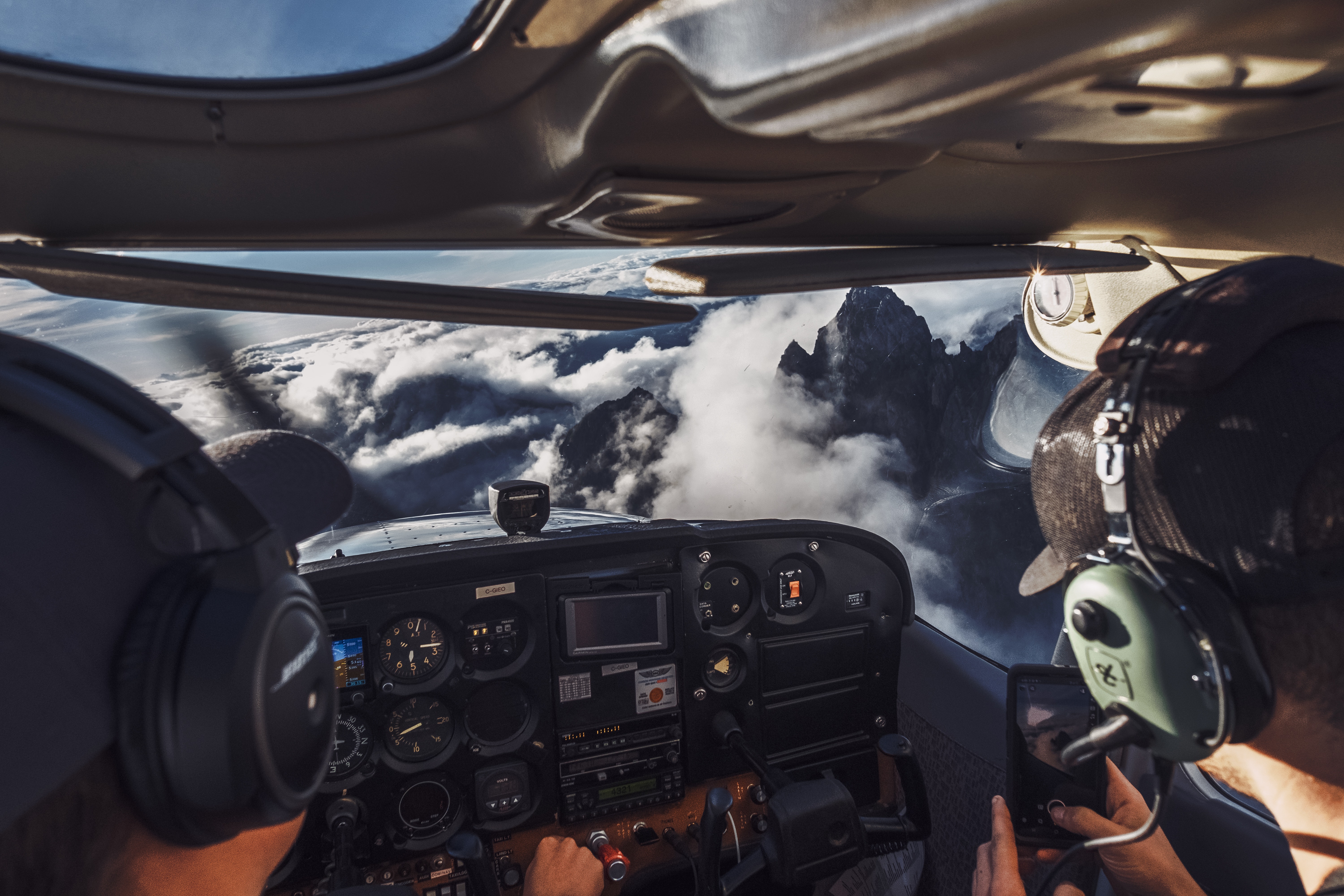 Microsoft Copilot and Office 365. A cockpit of a plane with clouds and mountains in the background.