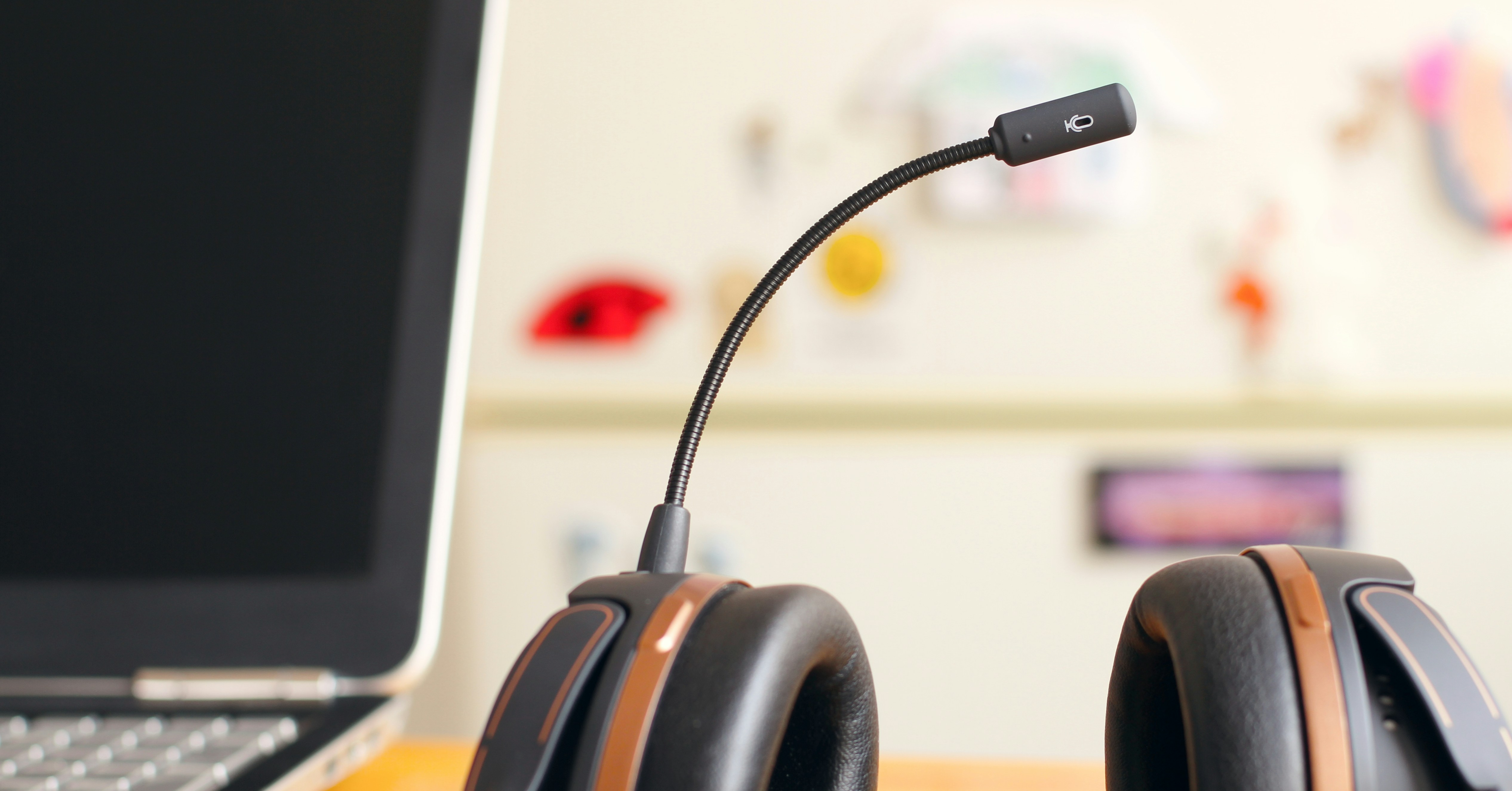 Contact Center Solutions Trends. A laptop and a headset sit on a desk, representing a contemporary and efficient workspace for productivity.