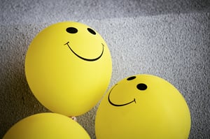 yellow-smiley-emoji-on-gray-surface-3612885