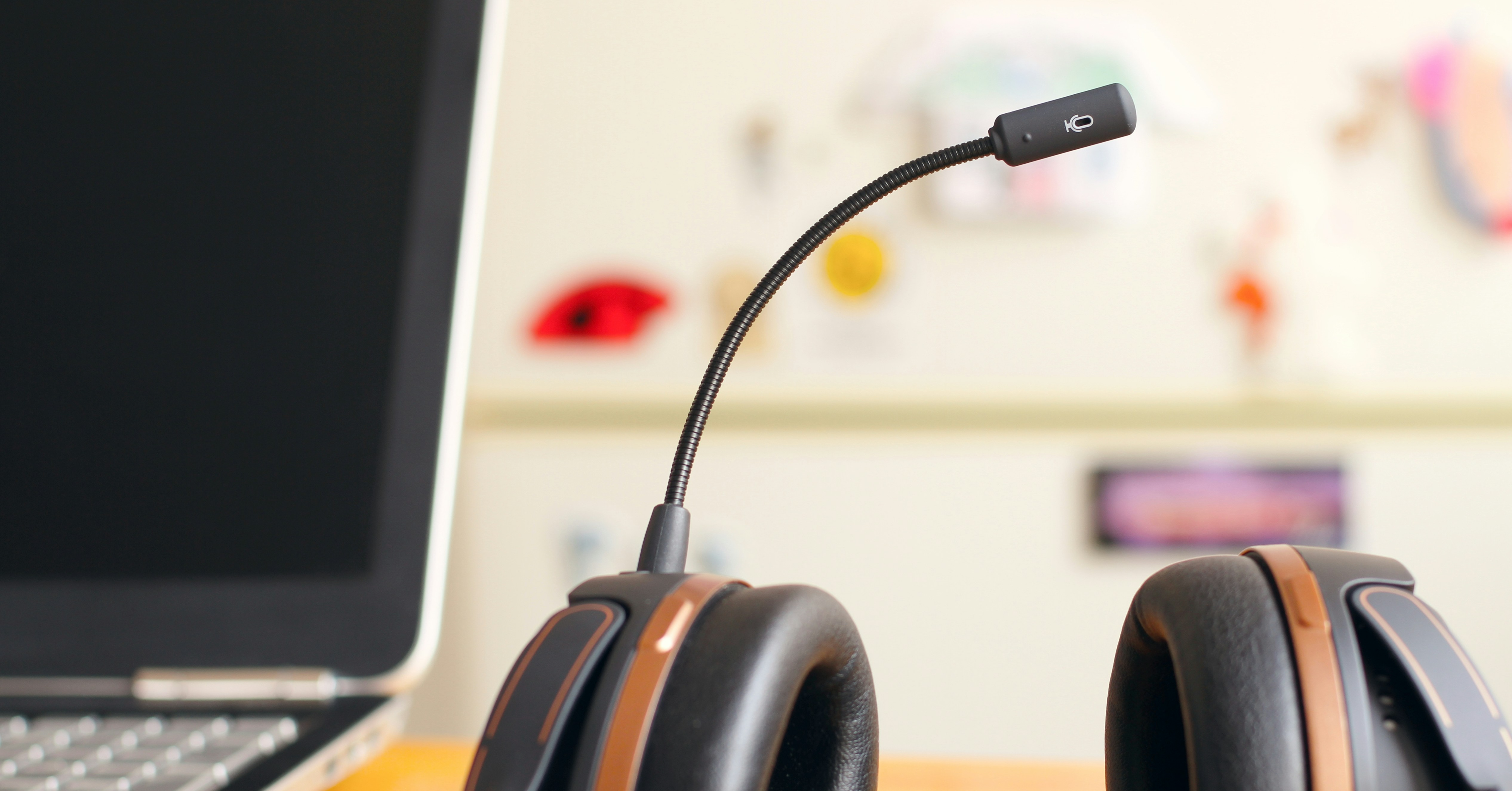 A laptop and a headset sit on a desk, representing a contemporary and efficient workspace for productivity.